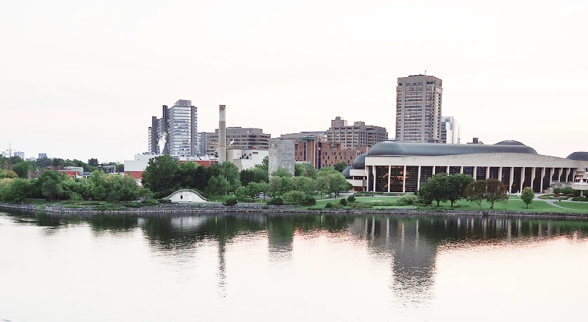 Skyline of Salford Quays reflected on the River Irwell, featuring theatres, modern architecture, and waterfront buildings.