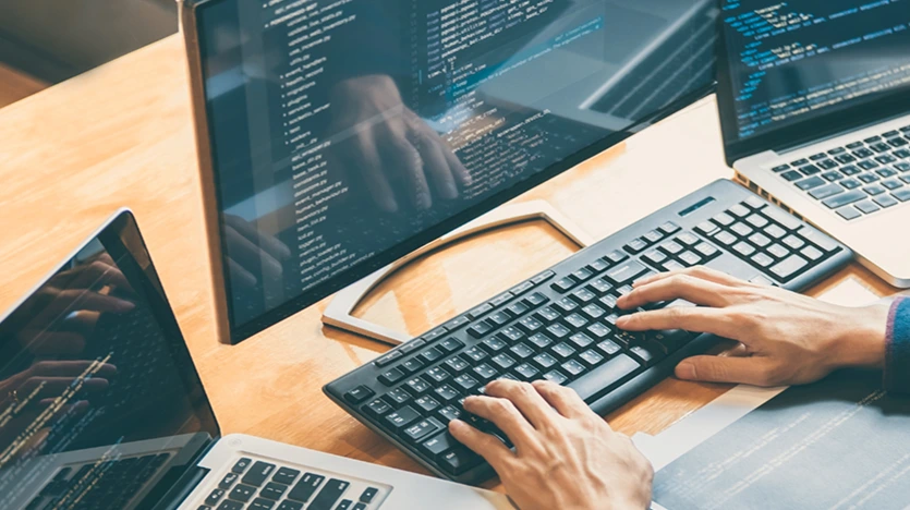Developer coding on multiple screens, representing AI integration and web innovation inspired by Google Gemini