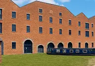 Front view of the Portland Basin Museum in Ashton-under-Lyne, a historic 1834 canal warehouse showcasing Tameside’s textile and coal heritage.